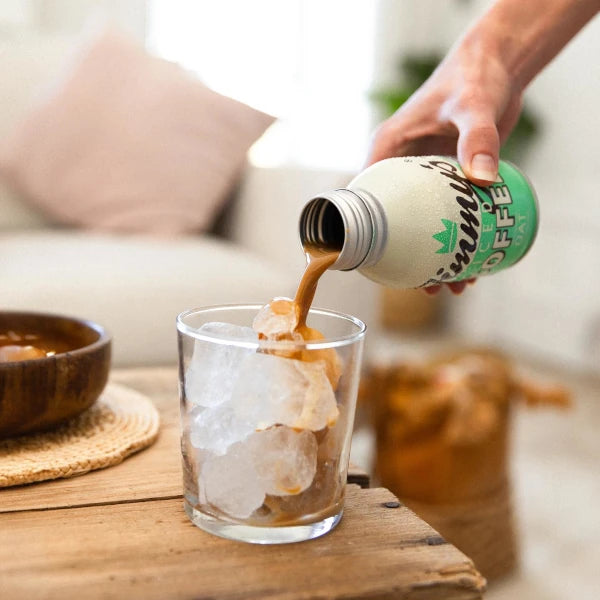 Jimmy's Iced Coffee Oat BottleCan 275ml being poured into a glass with ice