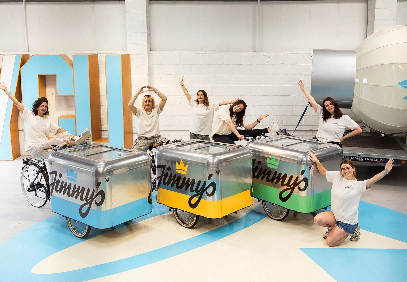 6 Jimmy's staff members posing around 3 Jimmy's Iced Coffee carts
