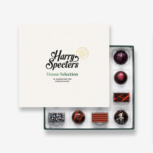 A vegan chocolate selection box containing 16 chocolates, partially covered by a lid showing the name Harry Specters. The chocolates seen within this gift box are a colourful mix of dark, plant-based, vegan-friendly chocolates.