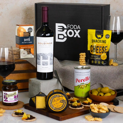 Wine & Cheese Gourmet Hamper red wine cheese and snacks on a wooden baord