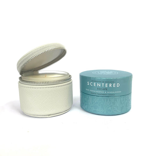 Scentered Escape Relaxation Travel Candle 85g in Vegan friendly zipper pouch next to coloured Escape Travel Candle packaging packshot