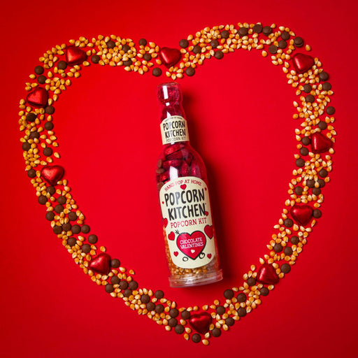 bottle of pop at home chocolate valentines surrounded by a heart made of popcorn kernels, chocolate buttons and red foil wrapped chocolate hearts