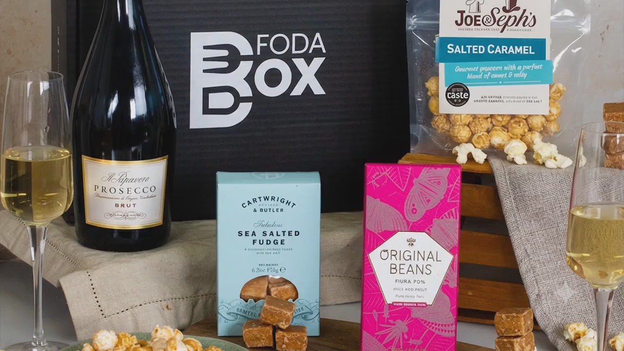 Load video: Video showing Prosecco and treats hamper with close up on products and two glasses being clinked