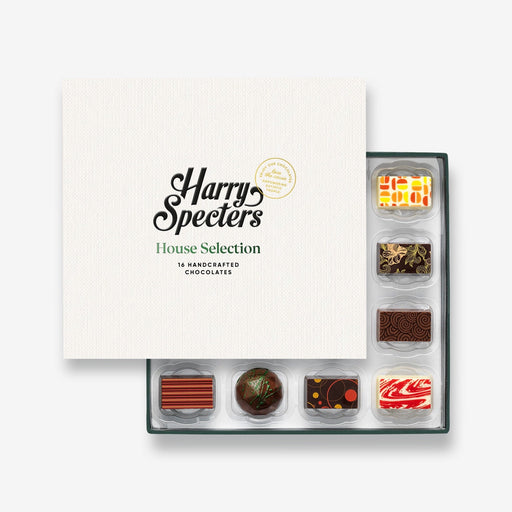 A chocolate selection box containing 16 chocolates, partially covered by a lid showing the name Harry Specters. The chocolates seen within this gift box are a colourful mix of white, milk, and dark chocolate.