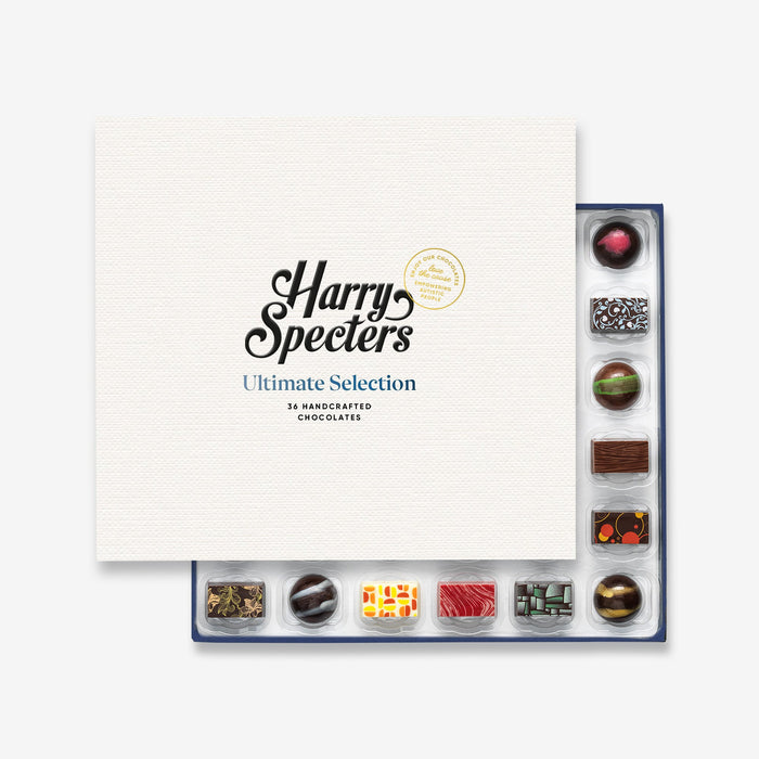 A chocolate selection box containing 36 chocolates, partially covered by a lid showing the name Harry Specters. The chocolates seen within this gift box are a colourful mix of white, milk, and dark chocolate with two Eid Mubarak message chocolates.