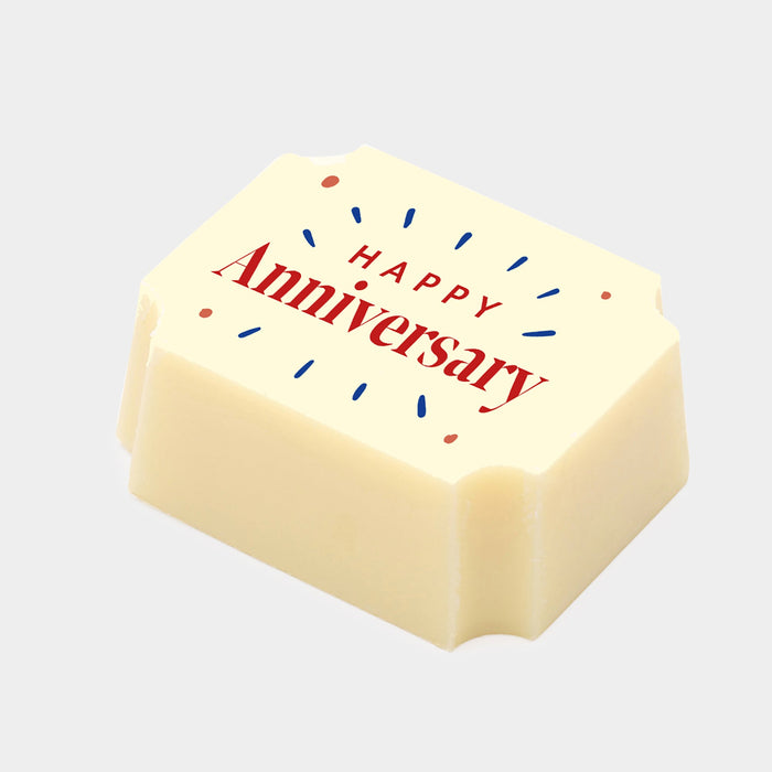 A white chocolate filled with dark chocolate ganache, made by Harry Specters, with a Happy Anniversary message printed on the top.