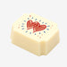 A white chocolate filled with dark chocolate ganache, made by Harry Specters, with Anniversary hearts printed on the top.
