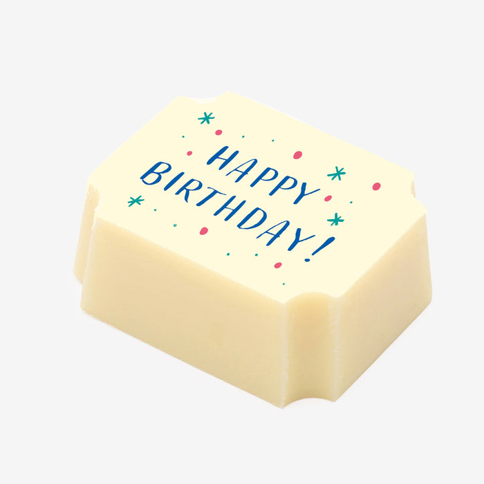 A white chocolate filled with dark chocolate ganache, made by Harry Specters, with a Happy Birthday message printed on the top.