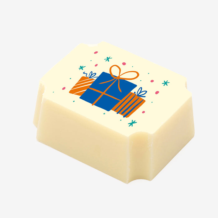 A white chocolate filled with dark chocolate ganache, made by Harry Specters, with birthday presents printed on the top.