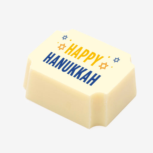 A white chocolate filled with dark chocolate ganache, made by Harry Specters, with a Happy Hanukkah message printed on the top.