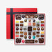An open chocolate selection box containing 55 chocolates made by Harry Specters. The chocolates seen within this gift box are a colourful mix of white, milk, ruby, caramel, and dark chocolate with coffee beans, mini chocolate bars, and hot chocolate buttons.