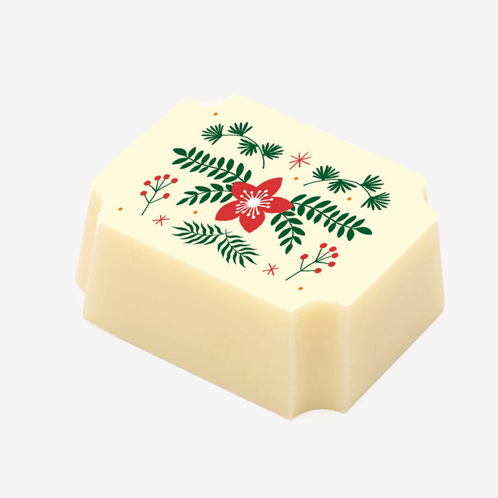 A white chocolate filled with dark chocolate ganache, made by Harry Specters, with a Merry Christmas themed image printed on the top.