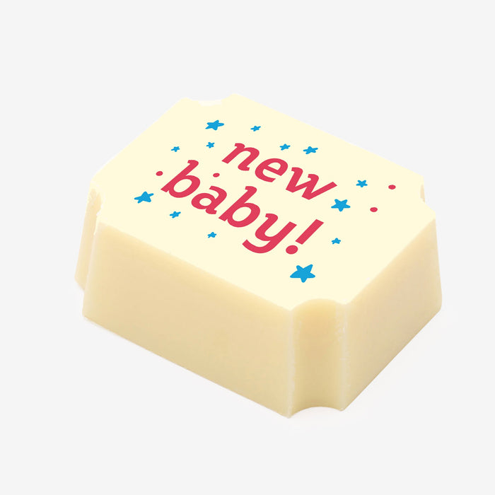 A white chocolate filled with dark chocolate ganache, made by Harry Specters, with a New Baby message printed on the top.
