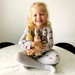 Child holding 3 Popcorn Kitchen Gift Bottles