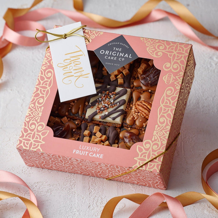 a box of salted caramel and date cakes with a thank you gift tag 
